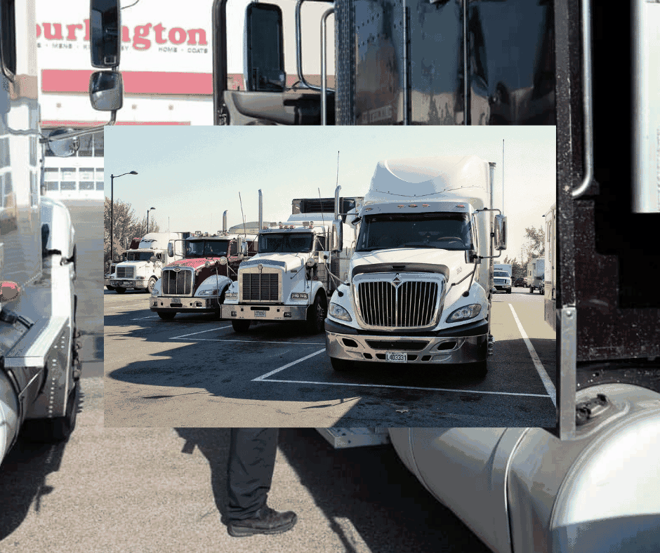 A commercial vehicle stopped at a roadside inspection station with an officer reviewing paperwork